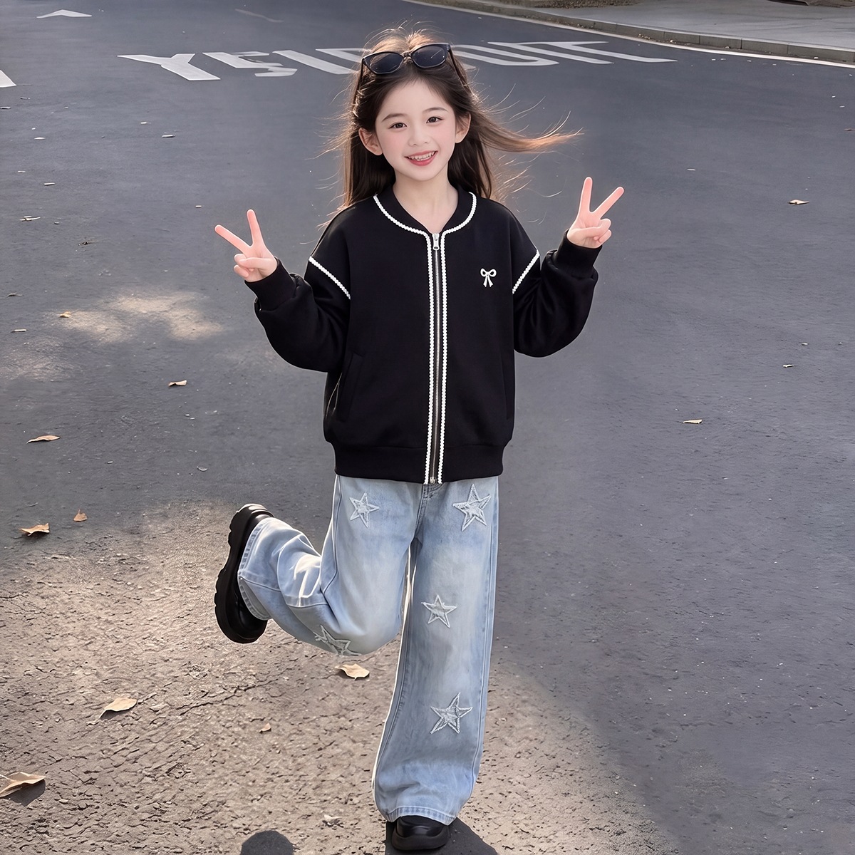 Girls' stylish two-piece set: a zip-up baseball jacket top paired with star-patterned casual jeans.