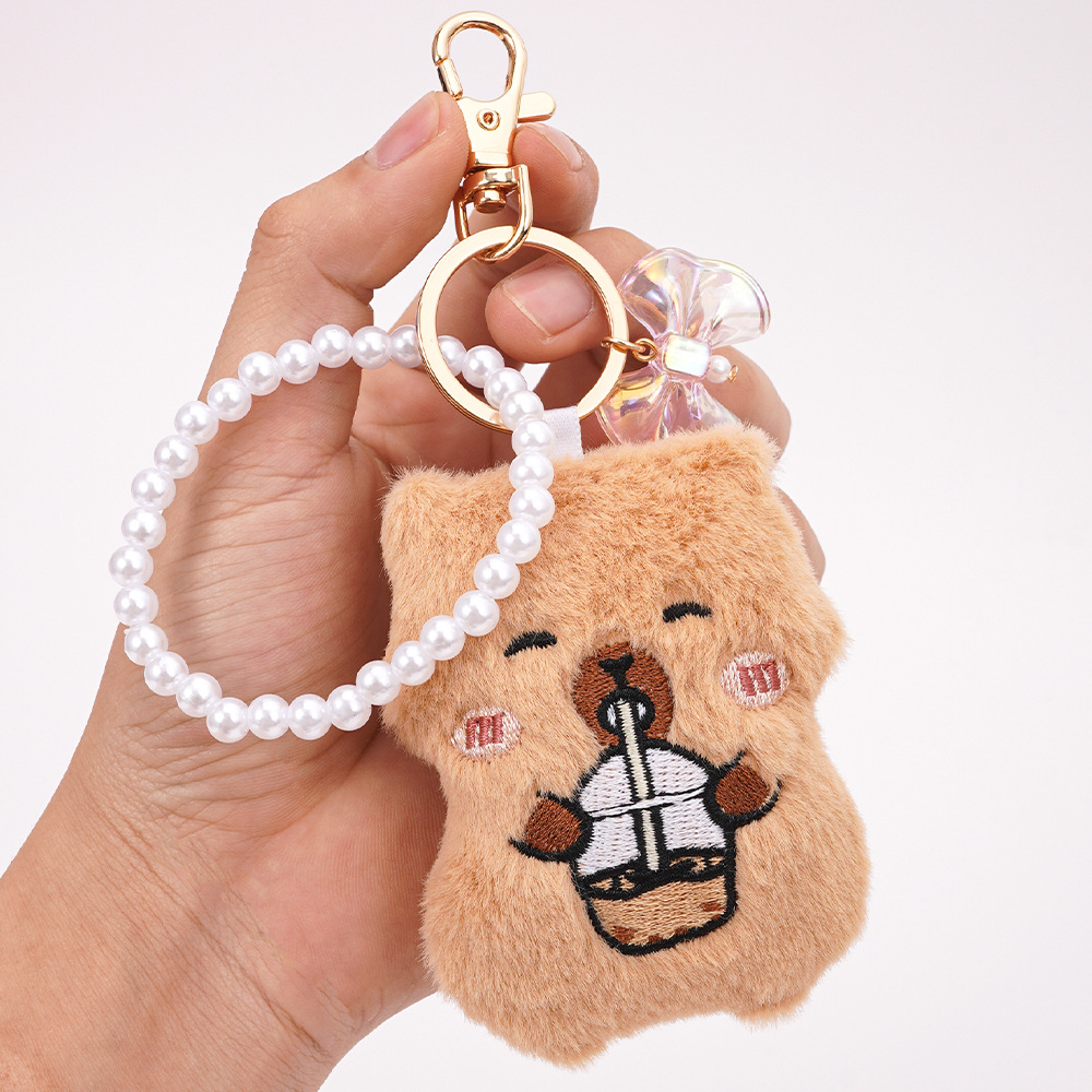 Colgante de bolso de animal de dibujos animados lindo Kapibala niña mochila llavero accesorios colgantes de perlas de felpa