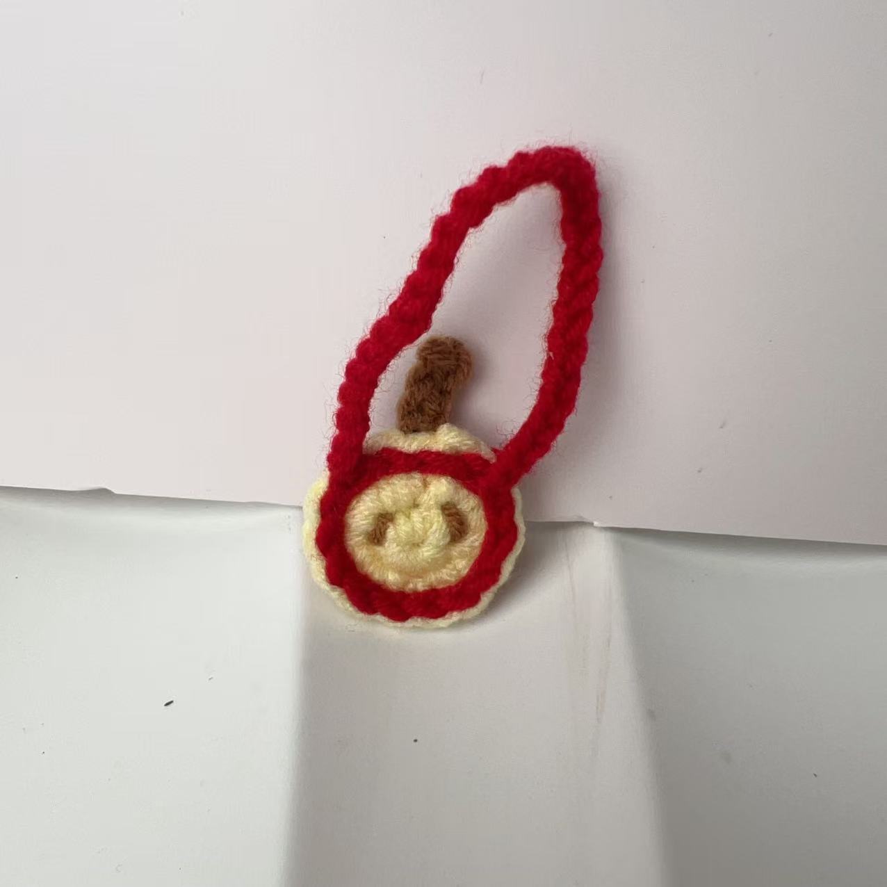 Red apple small hanging diagonally