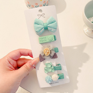 Hermosos clips de cabello de color para niños coreanos de alto nivel sensación de arco de niñas bolsa de tela no daña clips de cabello de bebé