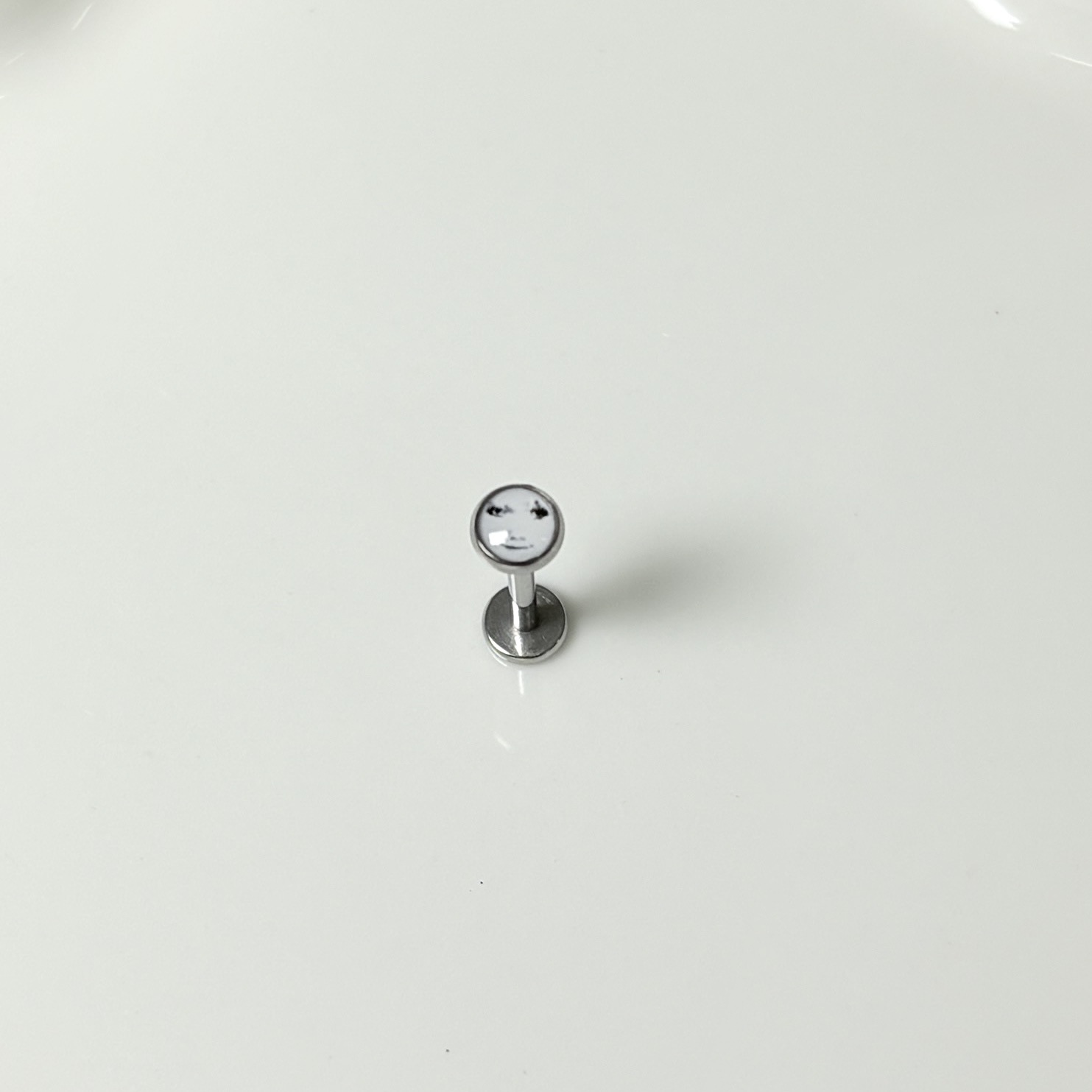 Silver pointed spike labret stud material detail