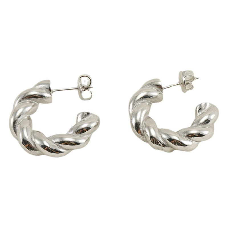 Pendientes de acero de titanio de giro europeo y americano transfronterizo hembra vacío galvanoplastia 18K moda de acero inoxidable torcido pendientes gruesos hembra