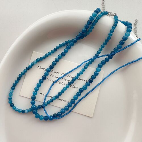 The blue bead necklace with a minimalist and niche design, exuding a sense of sophistication, similar to the one worn by Korean Instagram influencer Fever, for women.
