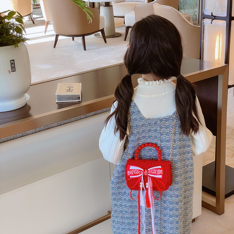 Bolsa de hombro de niña roja de Año Nuevo lindo arco borracha bolsa de bebé 2025 nueva cadena bolsa de niños