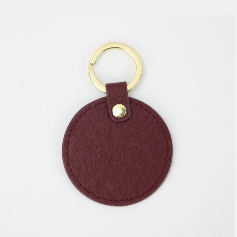 Llavero redondo de cuero genuino personalizado creativo simple colgante hombres y mujeres pequeño exquisito pequeño regalo al por mayor todo a juego