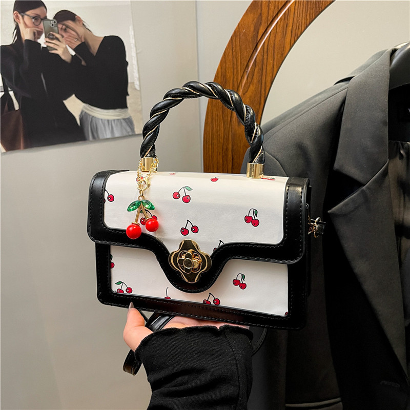 2025 nuevo bolso de mensajero con estampado de cereza lindo bolso cuadrado pequeño portátil girando bolso de niña de diseño de color de contraste fresco