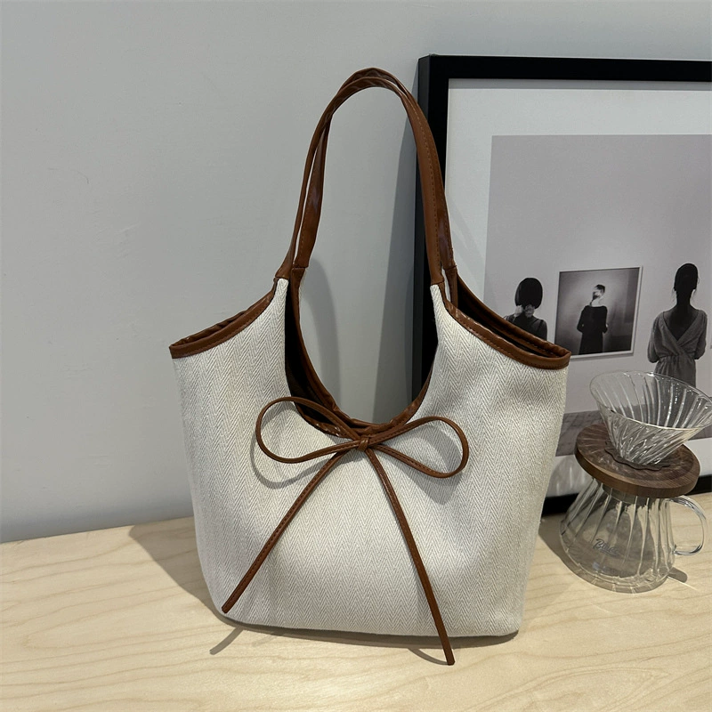 Capacious shoulder bag, one-shoulder bag with bow, western style