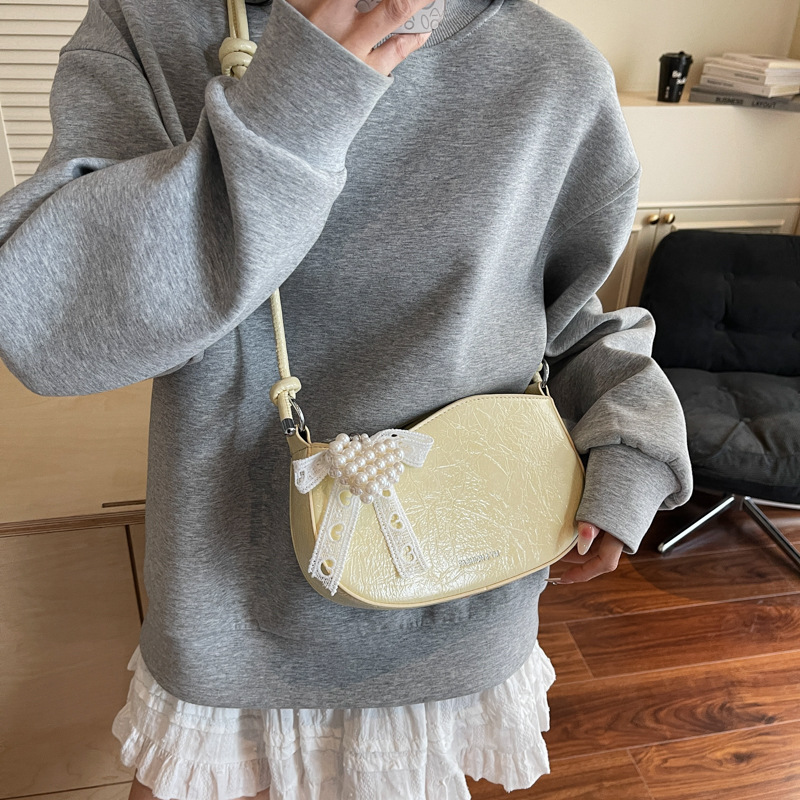 Bolsos pequeños de alta calidad 2025 verano nuevo estilo bolso femenino diseño de nicho bolso de hombro moda patrón de agarre de mano bolso de mensajero