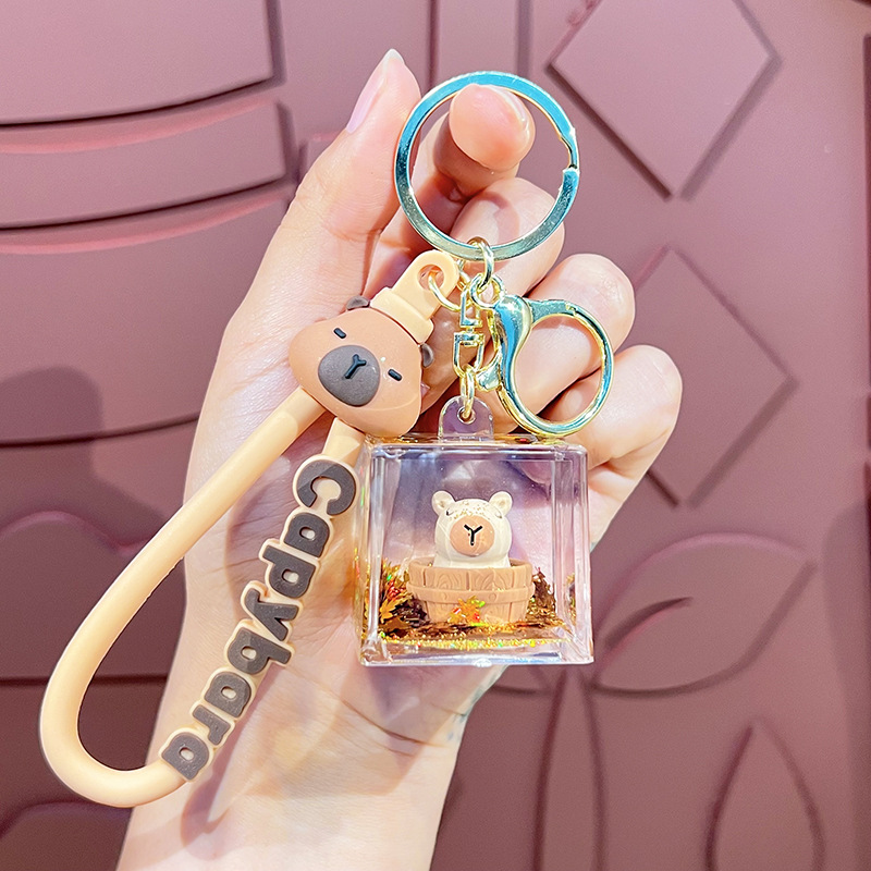 Cariño interesante en el aceite muñeca Kapibara llavero lindos colgantes delfines bolsa de automóvil garra máquina pequeños regalos al por mayor