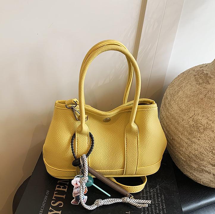 Nicho de moda explosivo bolso de cubo portátil para mujeres 2025 nuevo estilo universal simple bolso de mochila de moda extranjera bolso de mochila