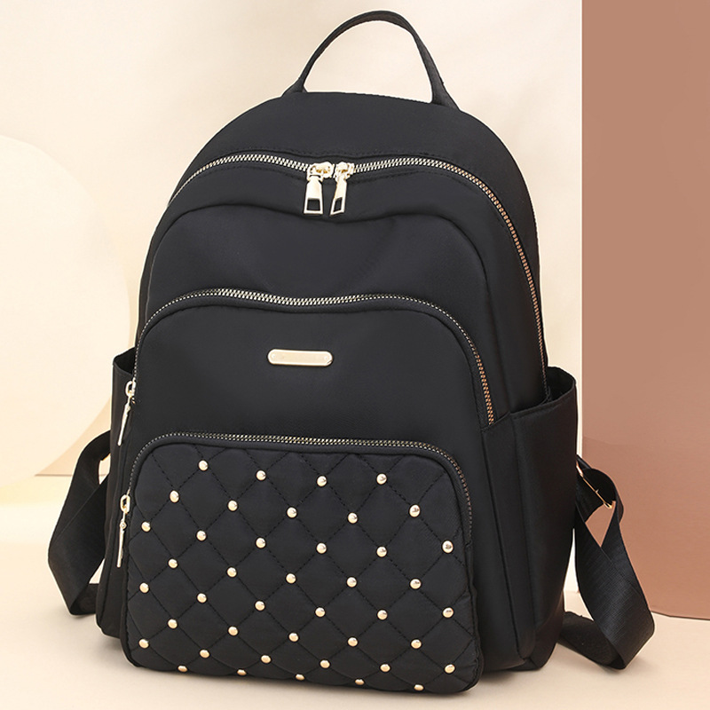 Comercio exterior al por mayor 2024 nuevo estilo casual señoras Lingge mochila moda remache color contraste mochila ligera mochila escolar marea