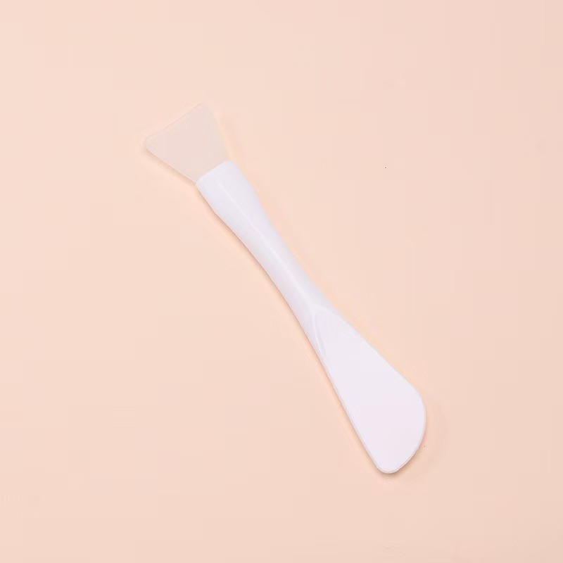 White mask brush with scraper