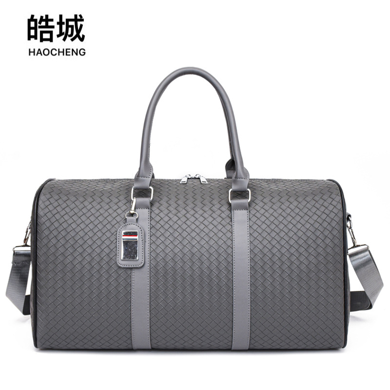 2024 Bolso de viaje portátil tejido nuevo transfronterizo de ocio de gran capacidad anti-salpicaduras de agua Bolso de equipaje de viaje de negocios de corta distancia