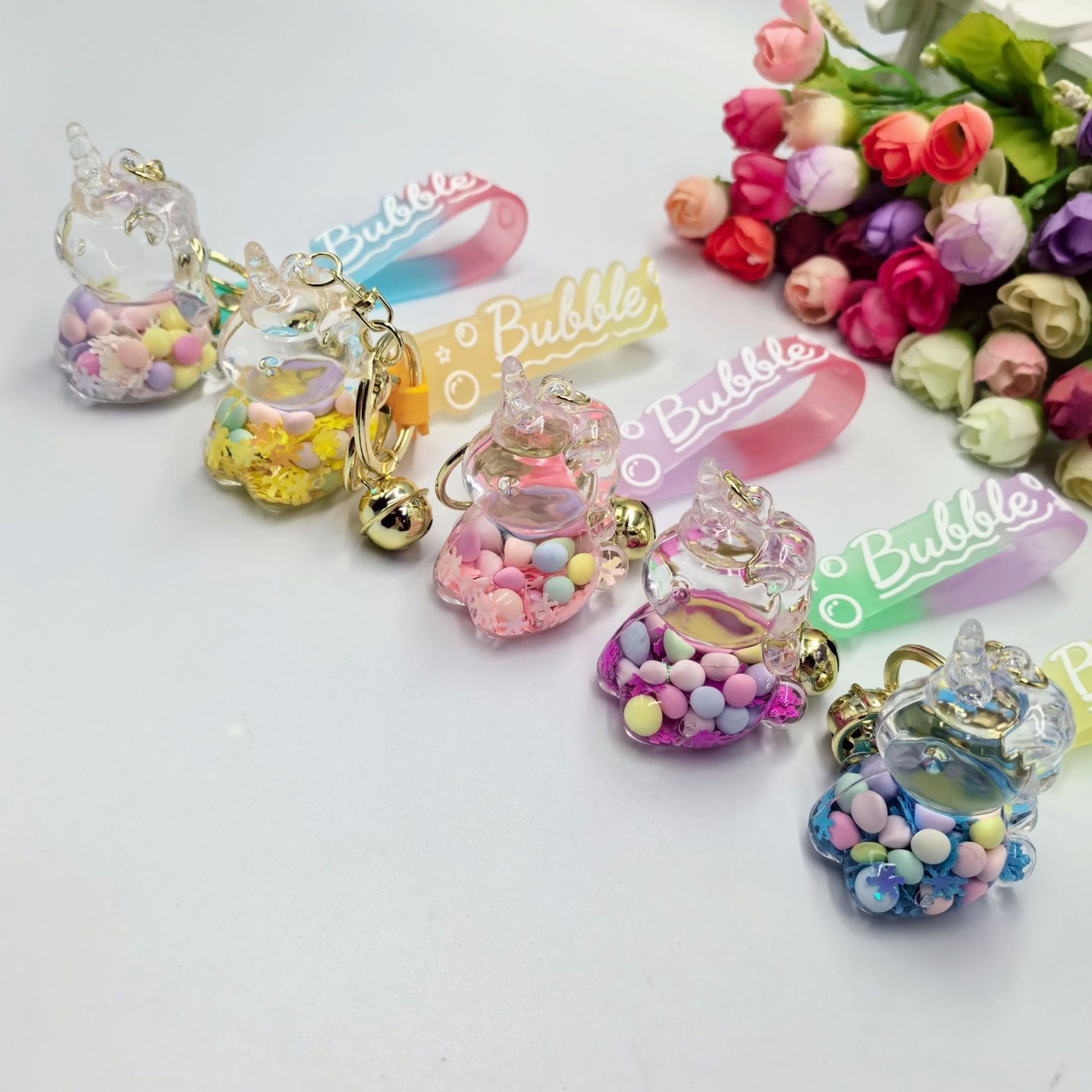 Aceite de copo de nieve azúcar colorido frijoles unicornio llavero colgante bolsas colgantes bolsas colgantes regalo creativo para estudiantes