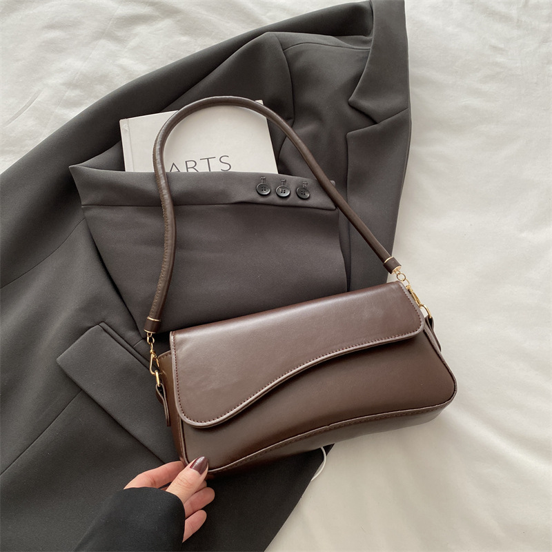 Bolso debajo de la axila para mujeres 2025 primavera nueva moda de alta sensación de hombro mochila de nicho bolso de textura cuadrada