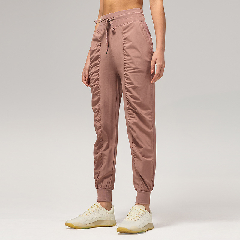 Pantalones deportivos casuales sueltos de mujer plegados para correr pantalones de yoga de nueve puntos de bolsillo secado rápido pantalones de pies transpirables