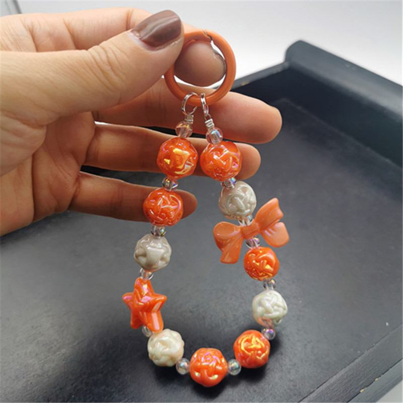 Colgante de estrella de cinco puntas con lazo naranja