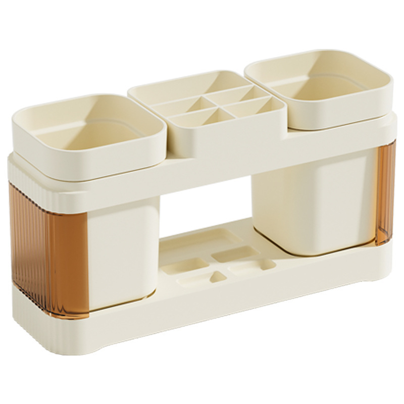 El baño de la Mesa de lavado de la pareja simple contiene un estante de taza de cepillo de dientes, un estante de taza de enjuague bucal de plástico, un estante de mesa de pasta de dientes.