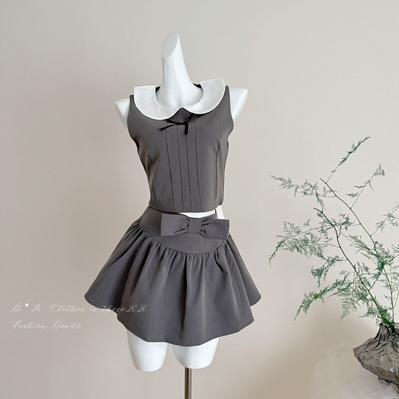 French-Style Asymmetrical Shoulder Top with Bowknot Doll Collar and Sleeveless Design / Pleated Short Skirt Set for Women French-Style Asymmetrical Shoulder Top with Bowknot Doll Collar and Sleeveless Design / Pleated Short Skirt Set for Women