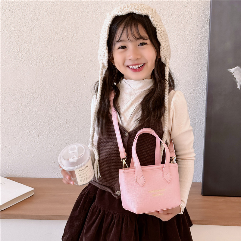 Bolsa de canasta de moda coreana para niñas simple color sólido bolso de balde de bebé 2025 nuevo bolso de comercio exterior para niños