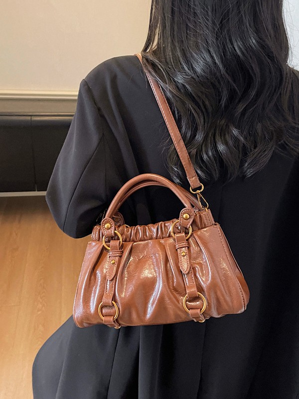 Retro bolso de mano plegable mujer 2025 otoño y invierno nuevo nicho de diseño bolso de cubo de viaje mochila de hombro