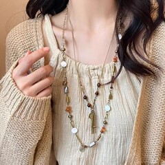 新中国式の古風な人はペンダントのネックレスの女性民族風の長いタイプの流蘇首のチェーンの小さい大衆の復古の百合のセーターのチェーンに似ています。