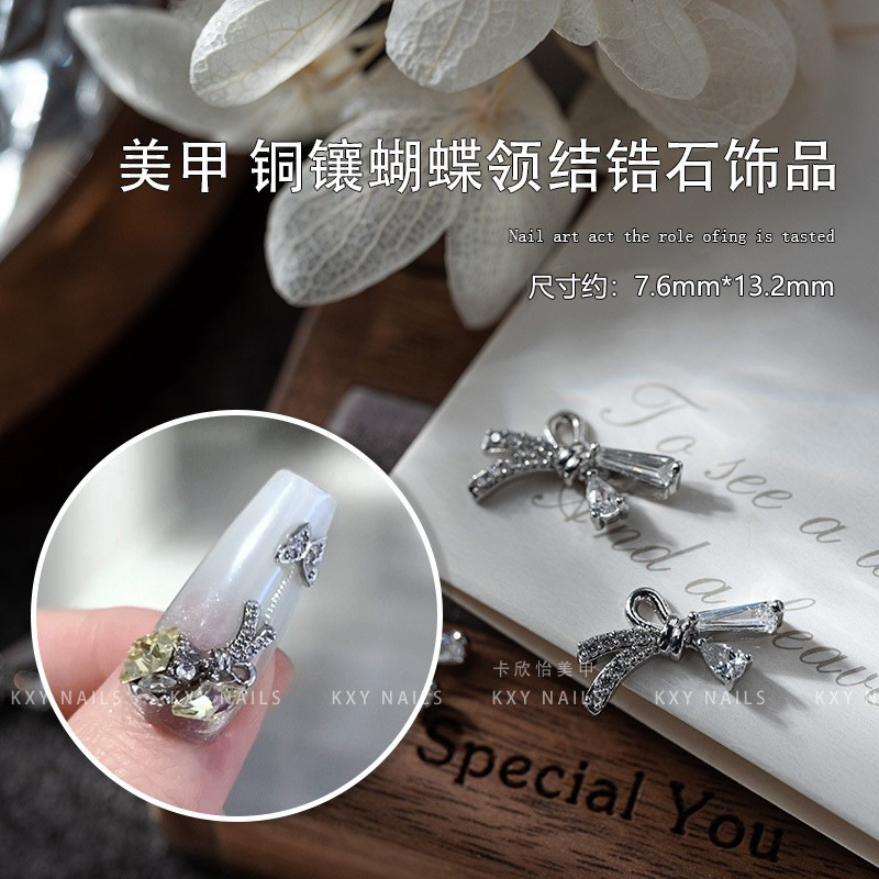 Clavo cobre con incrustaciones mariposa pajarita circón pequeña joyería Retención de color avanzado de lujo ligero tridimensional popular en línea popular accesorios de uñas