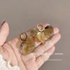 Gold hollow heart-shaped petal tassel earrings
