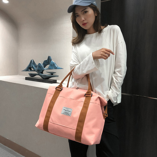 Manufacturer wholesale new travel bag LOGO shoulder bag large capacity short distance handbag luggage bag foreign trade wholesale