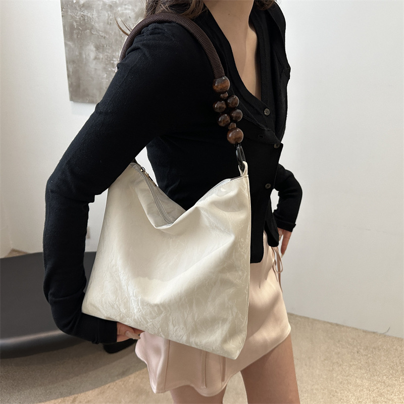 Nueva bolsa de estilo chino para mujeres 2024 verano nuevo estilo simple de moda seda bolso inferior nicho universal bolso de hombro casual