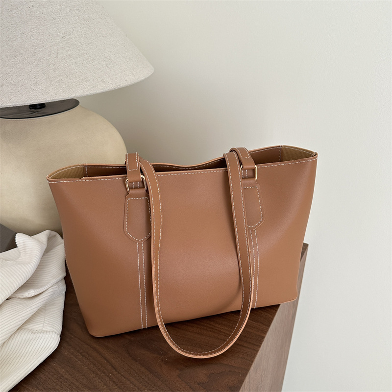 Bolso de viaje de alta gama retro 2025 primavera nuevo estilo salvaje ins color sólido bolso de hombro de trabajo bolso Tote