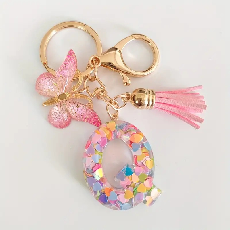 2024 transfronteriza en stock resina rosa con lentejuelas 26 letras inglesas llavero colgante mariposa borla Accesorios