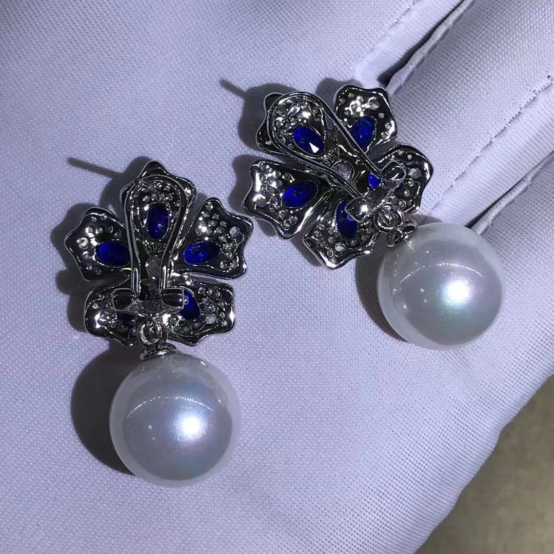 S925 Chapado en plata de cinco capas de espesor de platino con incrustaciones de conchas de perlas desmontables pendientes de zafiro de alta gama joyería de comercio exterior