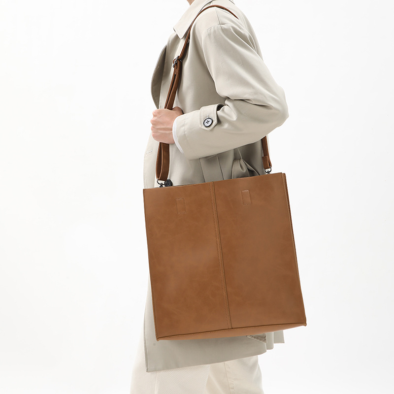 Korean version of fashionable PU leather shoulder bag, simple commuter men's and women's tote bag, square vertical crossbody large-capacity handbag_voghion.com