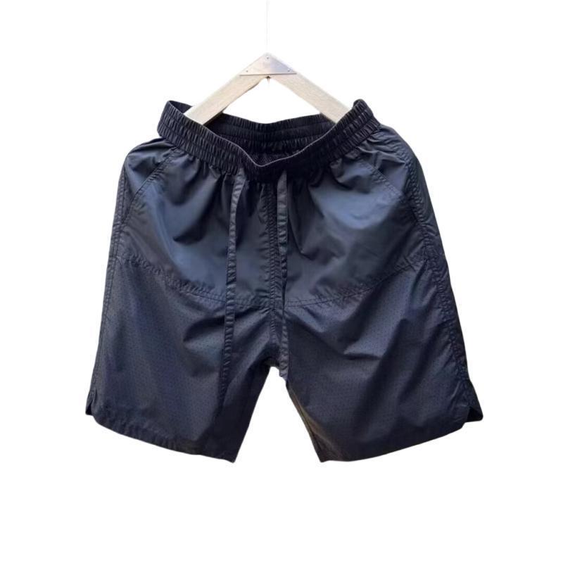 Verano nuevo estilo de secado rápido suelto tendencia casual perforado pantalones de cinco puntos moda masculina pantalones deportivos fríos y transpirables