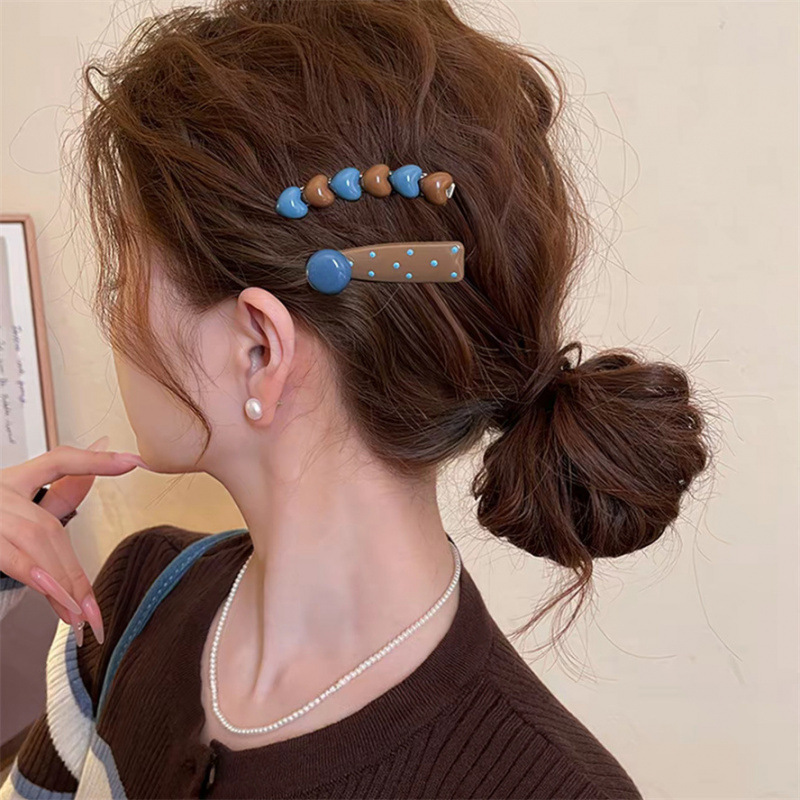 A pair of love polka dot hairpins