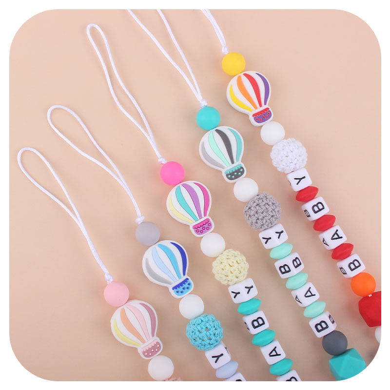 Bebé de dibujos animados de color globo de aire caliente de silicona teether personalizable nombre del bebé pezón anti-caída cadena teether traje