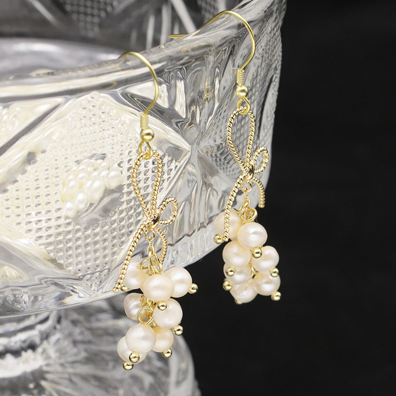 organic woven brand earrings from pearl with bow