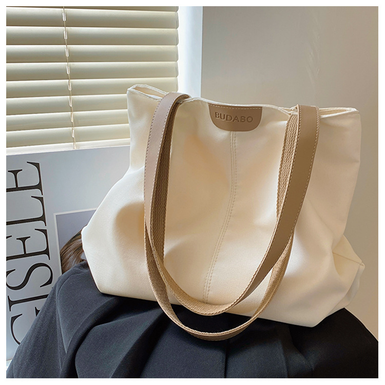 Bolso de lona unicolor de gran capacidad para mujer, nueva colección 2025, estilo japonés casual, bolso de hombro para estudiantes universitarios.