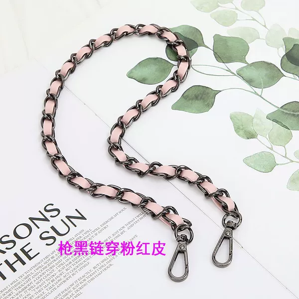 Black chain of gun wearing pink leather