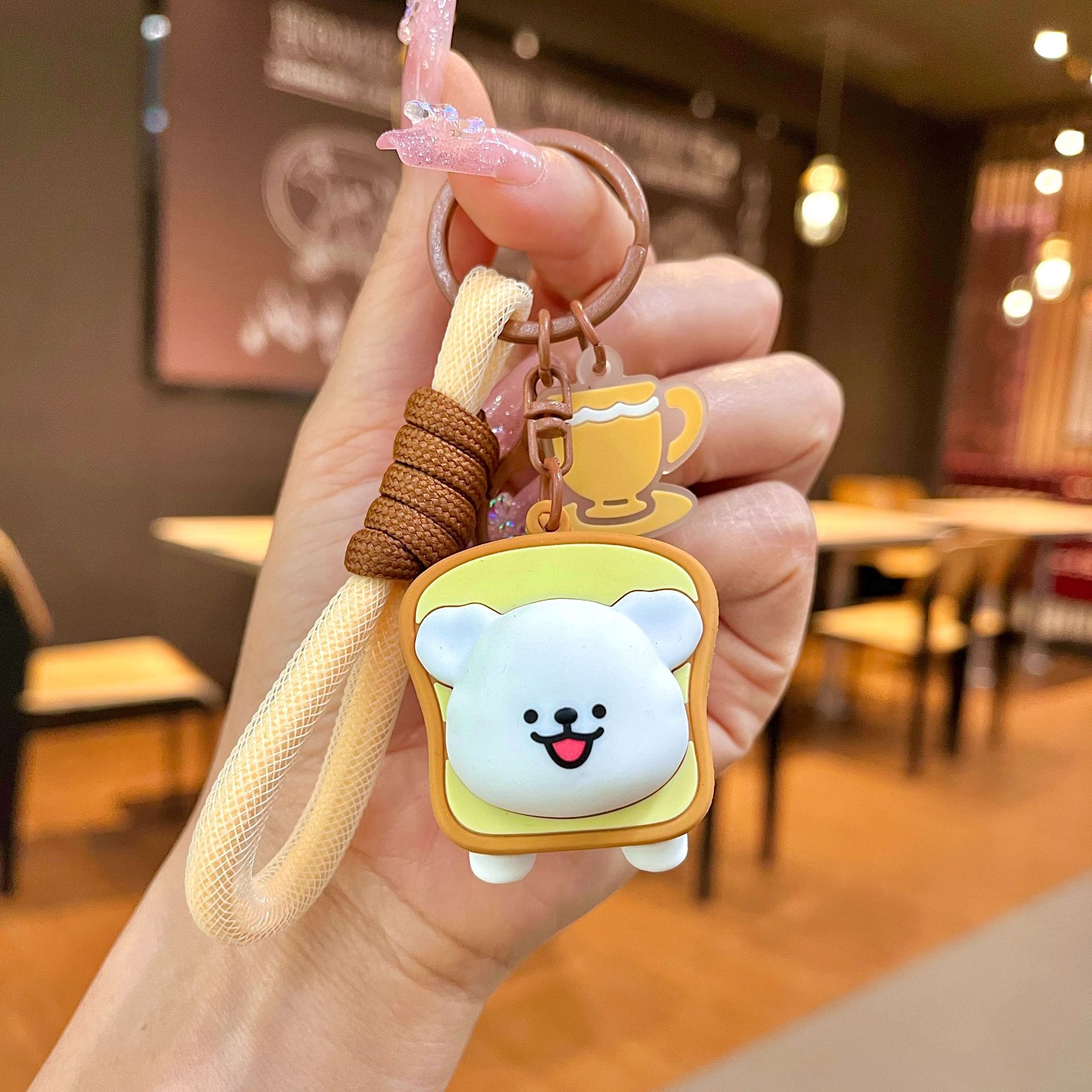 Línea de fábrica de llaveros perros en línea al por mayor postre popular cabeza cubierta de llaves de automóvil muñeca pequeña decoración de regalo