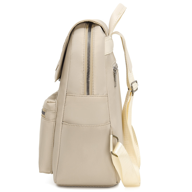 Mochila de color sólido para mujer 2025 moda coreana simple y salvaje mochila de tela Oxford mochila de viaje de ocio para mujer al por mayor