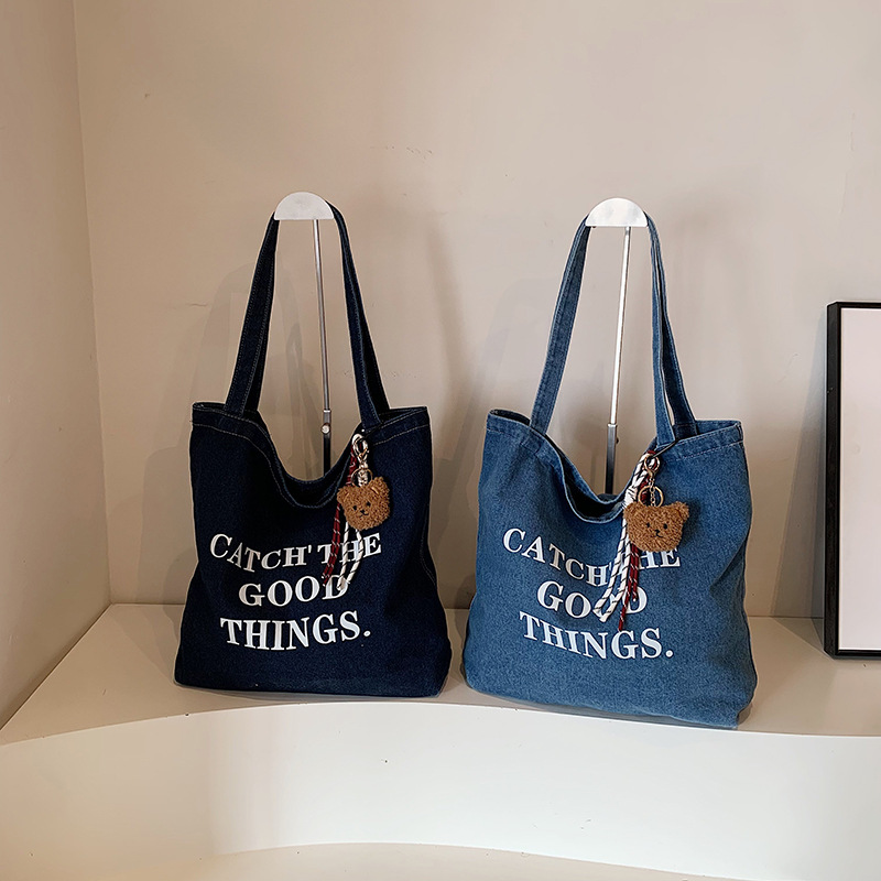 Bolsa de vaquín casual americana para estudiantes universitarios de clase viaje de compras letras de viento perezoso portátil gran capacidad bolso de hombro