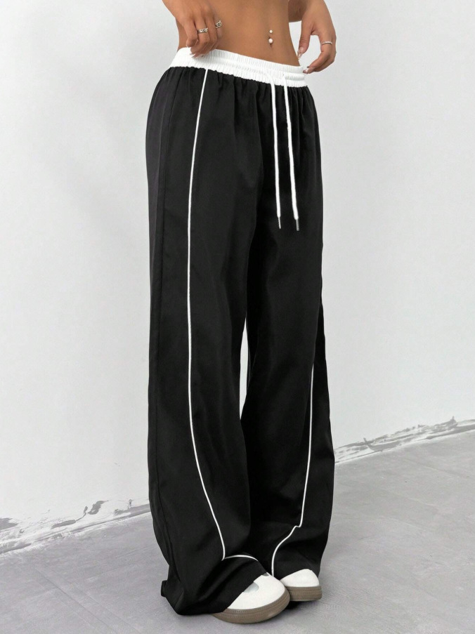 Europa y los Estados Unidos transfronterizos de otoño y invierno 2025 moda nuevos pantalones deportivos negros de mujer sueltos ociosos nichos de piernas largas
