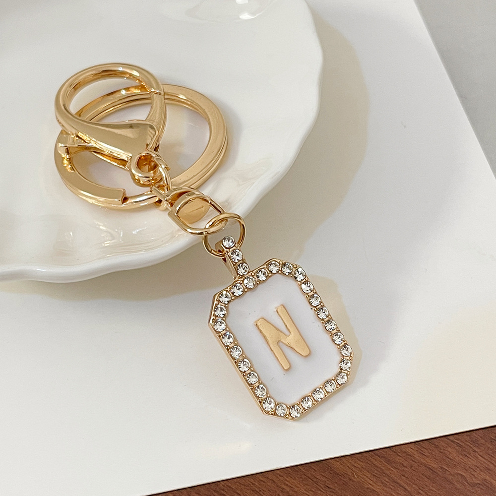 Nueva moda 26 cartas gota de diamante aceite llavero bolso del auricular pareja colgante vacaciones pequeño regalo al por mayor