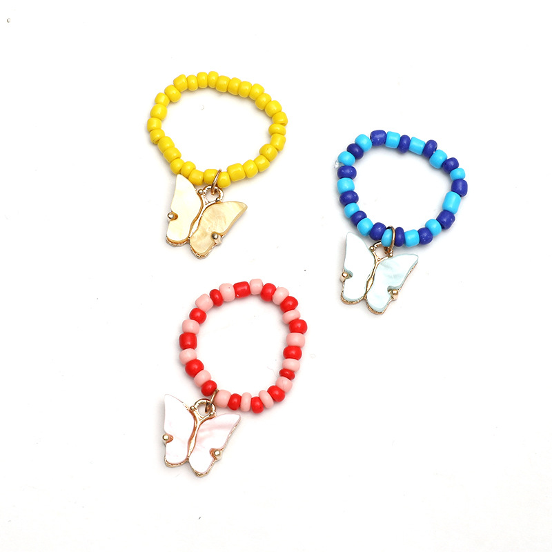 Simple Hand-woven Rice Bead Ring Fashion Temperament Butterfly Moon Star Pendant Elastic 3-piece Set display picture 1