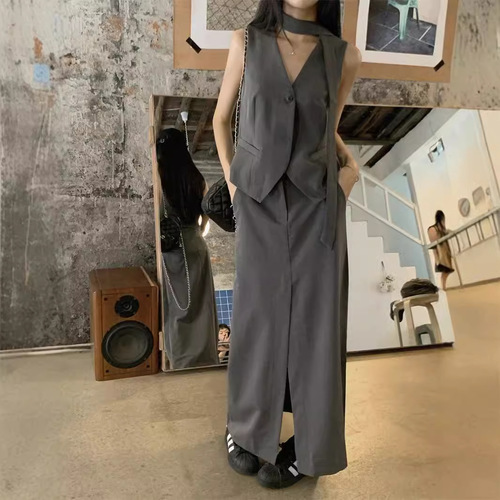 A vintage-style suit set with a sleeveless gray waistcoat for women, featuring a half-body skirt with slits for summer, exuding a sense of elegance - a two-piece set.