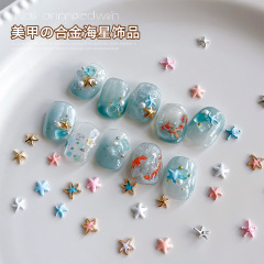 海星の合金のネイルアクセサリーの精巧な甘い風の百合の金の銀色のピンクの尖ったドリルの爪の装飾品の卸売り
