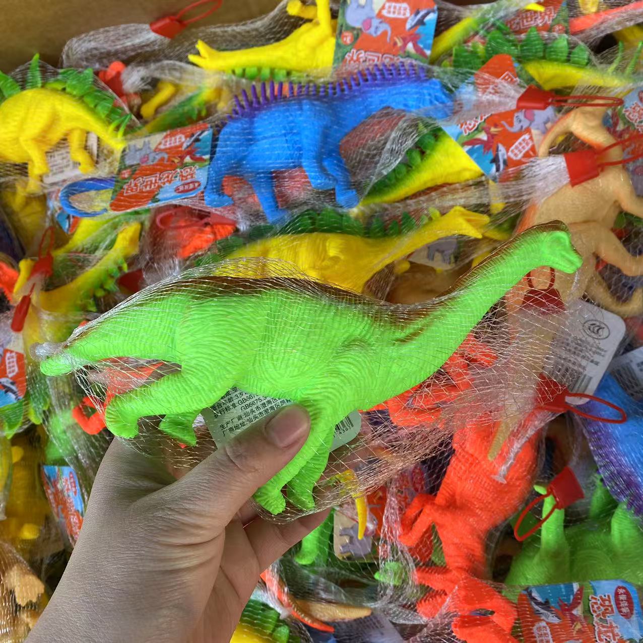 Juguetes infantiles simulación de piel de dinosaurio pellizco pellizco bolsas de red con sonido animal modelo de juguete colorido 2 yuanes al por mayor