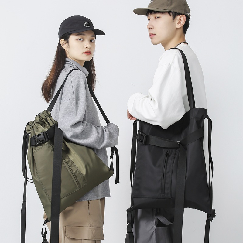 大容量單肩托特包抽繩潮酷兜子飄帶挎包2023春季新款純色雙肩大包